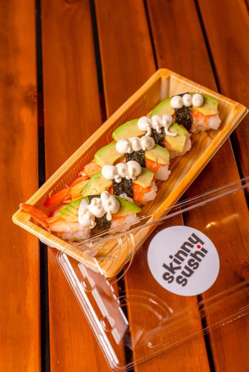 Salmon and avocado nigiri in a takeaway tray