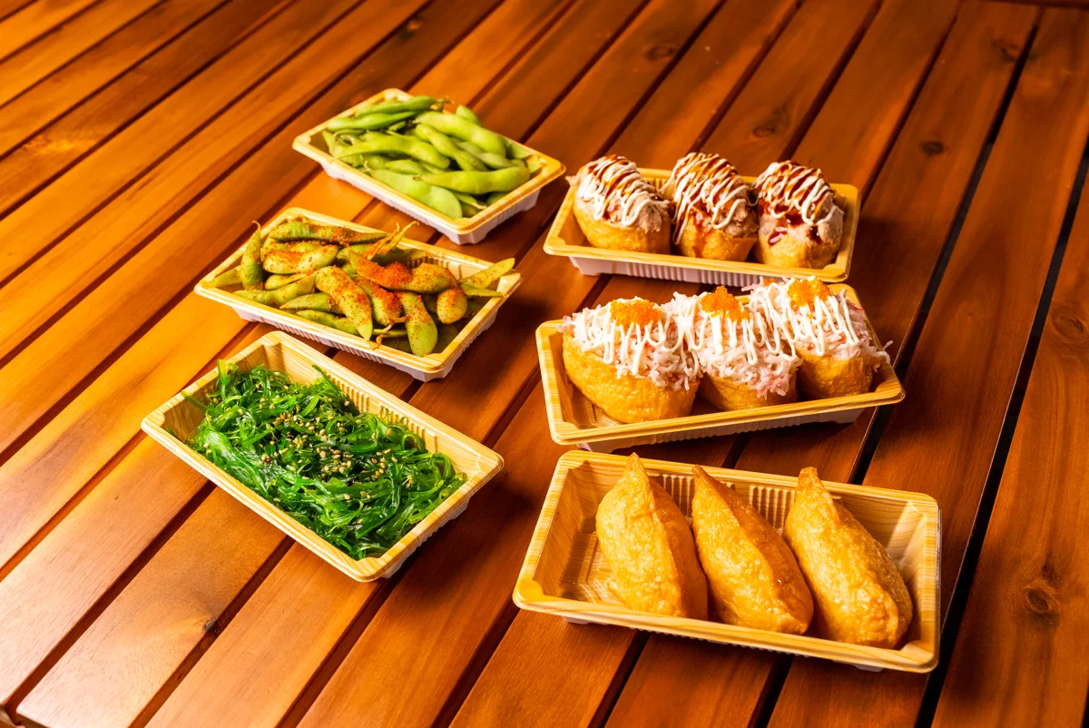 Skinny Sushi inari, edamame and seaweed salad on a timber table